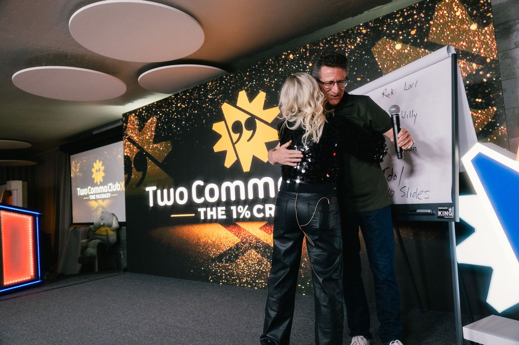Sarah on stage at Two Comma Club X after presenting