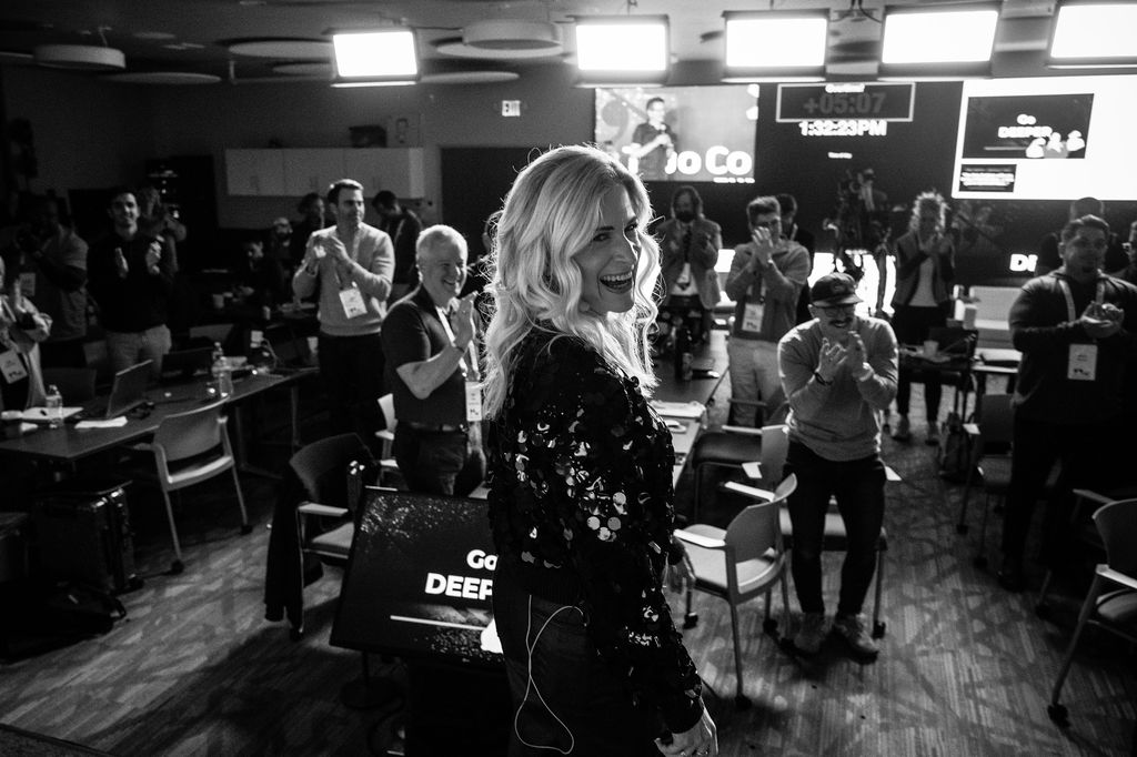 Sarah Grace Allred smiling while the 2CCX room gives a standing ovation